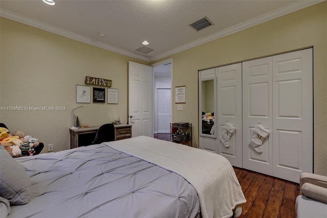 bedroom with crown molding, a closet, dark wood-type flooring, and a textured ceiling