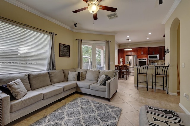 living room featuring ceiling fan, light tile patterned flooring, and ornamental molding