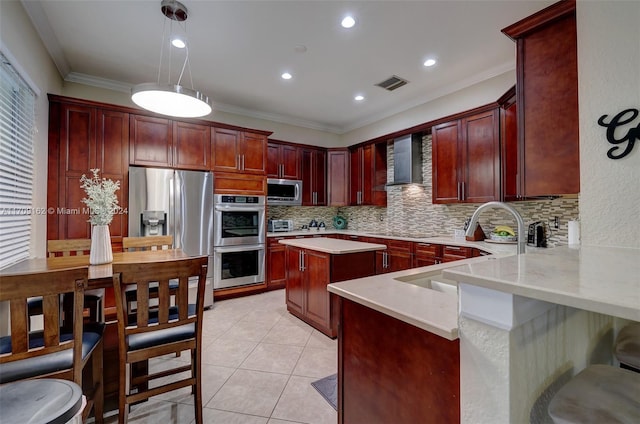 kitchen featuring crown molding, sink, wall chimney exhaust hood, appliances with stainless steel finishes, and decorative light fixtures