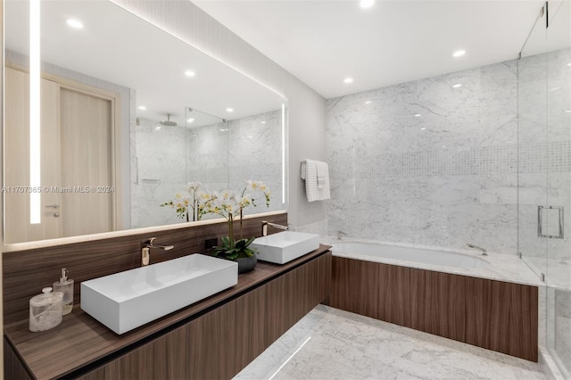 bathroom with vanity and independent shower and bath