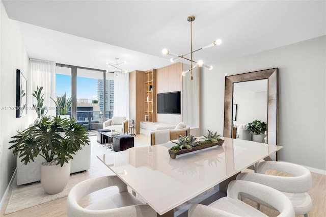 dining room with a wall of windows, light hardwood / wood-style flooring, and a chandelier