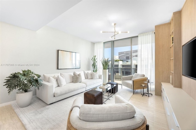 living room with floor to ceiling windows, a chandelier, and light wood-type flooring