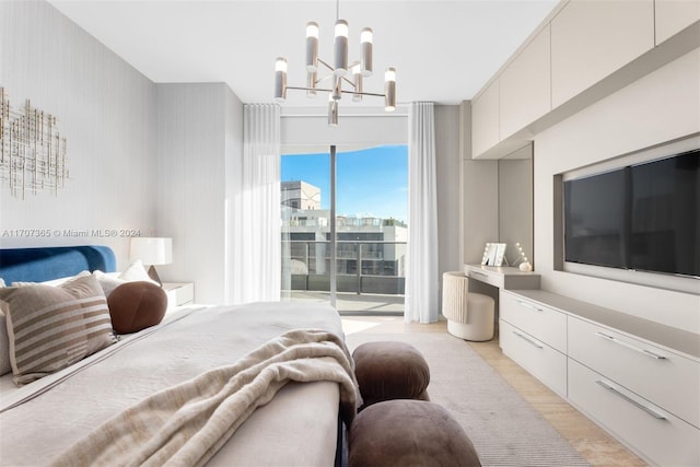 bedroom with light hardwood / wood-style flooring and an inviting chandelier