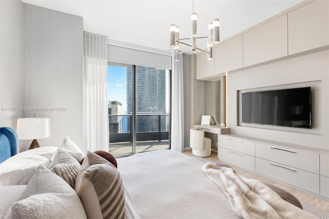 bedroom featuring access to outside and a notable chandelier