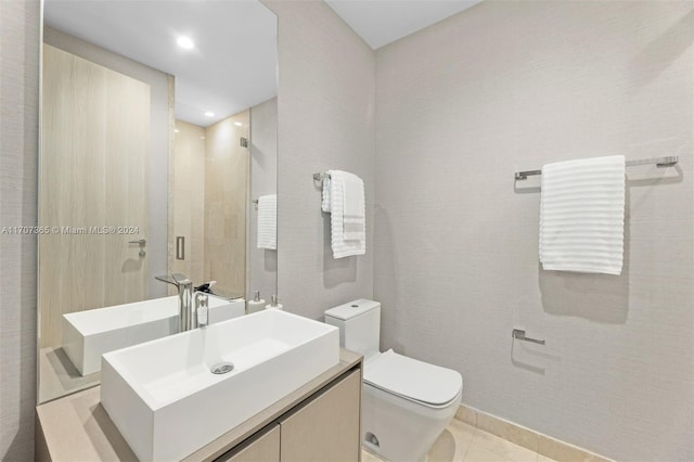 bathroom featuring toilet, vanity, and tile patterned floors