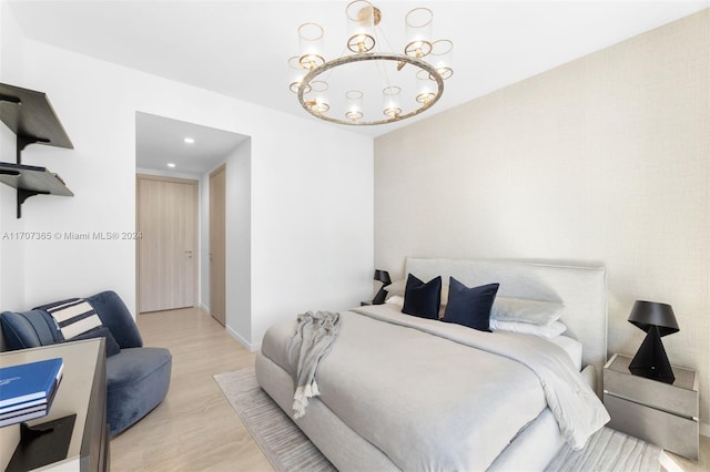 bedroom featuring light hardwood / wood-style flooring and a notable chandelier