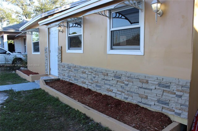 1918 NW 82nd St, Miami, FL 33147 - view of property exterior with stone siding and stucco siding