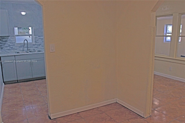 hallway with sink and light tile patterned flooring