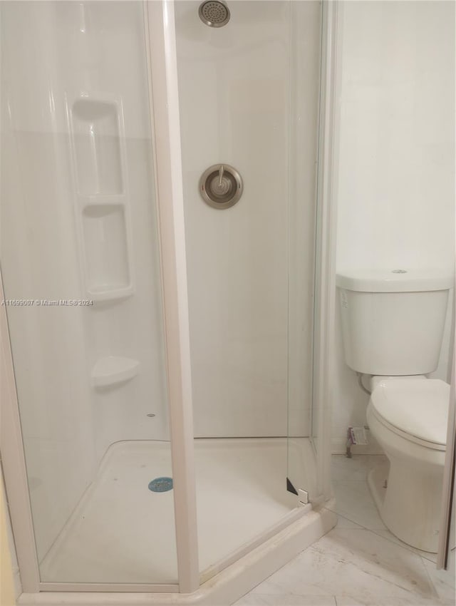 bathroom with toilet and walk in shower