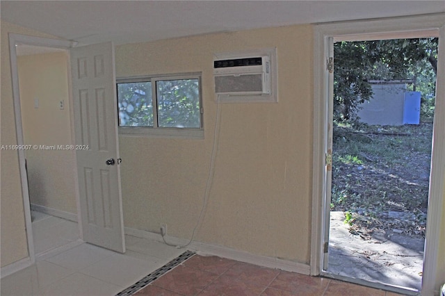 doorway featuring tile patterned floors and a wall unit AC