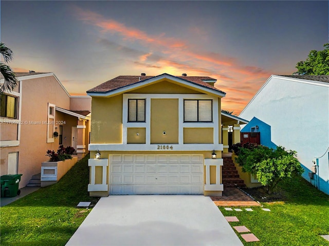 view of front of property with a lawn and a garage