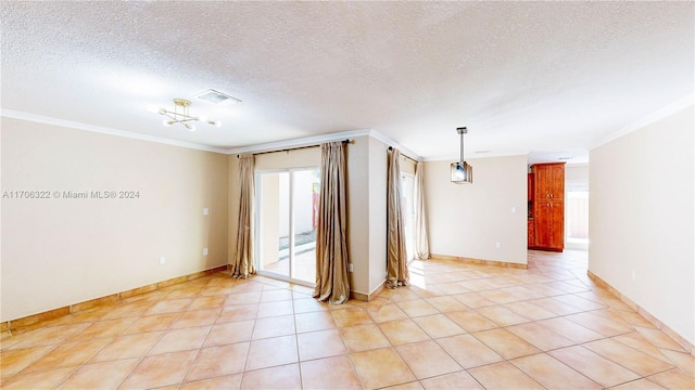 spare room featuring crown molding, light tile patterned floors, and a textured ceiling