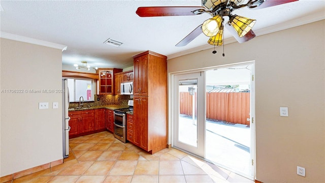 kitchen with decorative backsplash, crown molding, sink, and appliances with stainless steel finishes