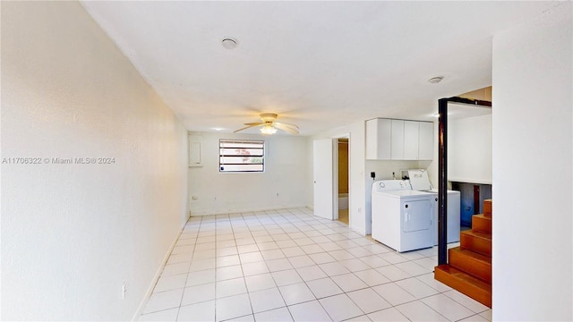 interior space featuring ceiling fan, cabinets, light tile patterned floors, and washing machine and dryer