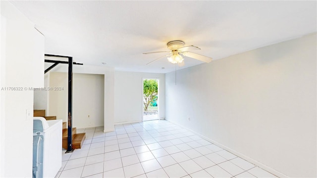 empty room with separate washer and dryer, ceiling fan, and light tile patterned flooring