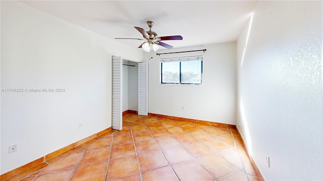 unfurnished room with light tile patterned floors and ceiling fan