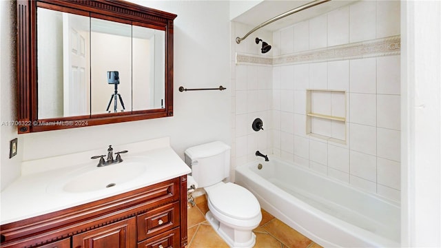 full bathroom with vanity, tiled shower / bath combo, toilet, and tile patterned flooring