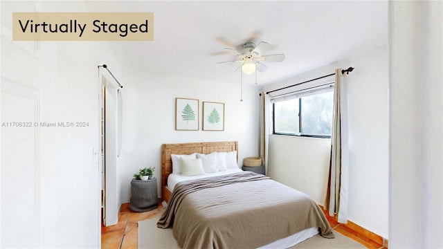 bedroom with light hardwood / wood-style floors and ceiling fan