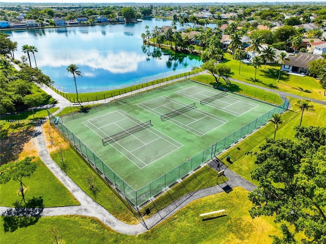 view of tennis court with a water view