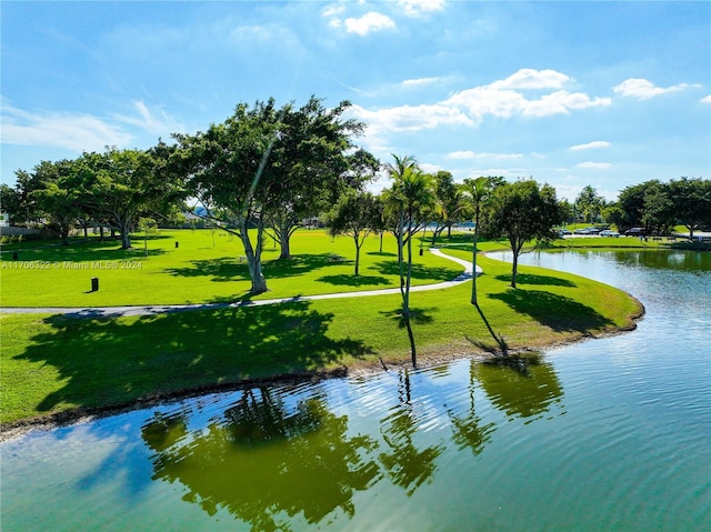 view of property's community with a water view and a yard