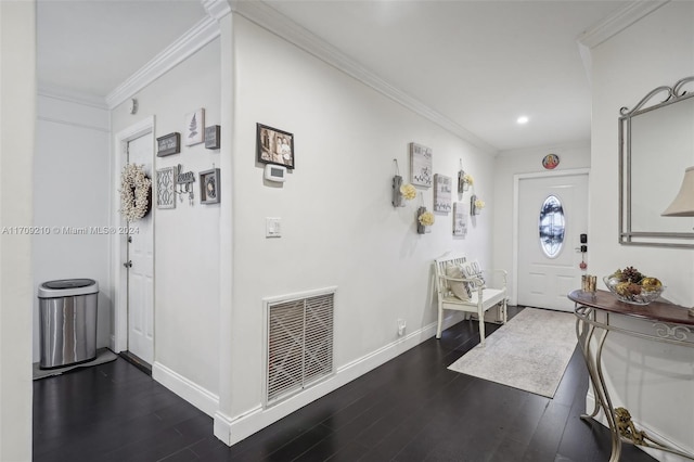 foyer entrance with dark hardwood / wood-style floors and crown molding