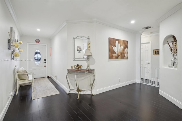 foyer with dark hardwood / wood-style flooring and ornamental molding