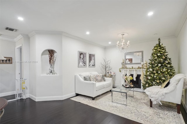 living room featuring a chandelier, hardwood / wood-style flooring, and ornamental molding