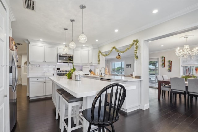 kitchen featuring backsplash, white cabinets, dark wood-type flooring, and appliances with stainless steel finishes