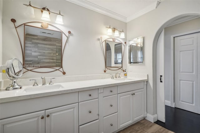 bathroom featuring hardwood / wood-style floors, vanity, and crown molding