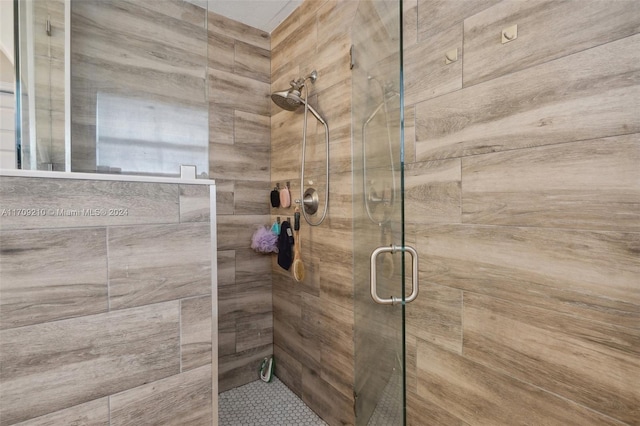 bathroom with a shower with shower door