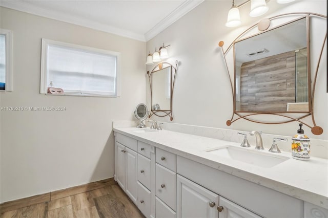 bathroom with crown molding, vanity, and hardwood / wood-style flooring