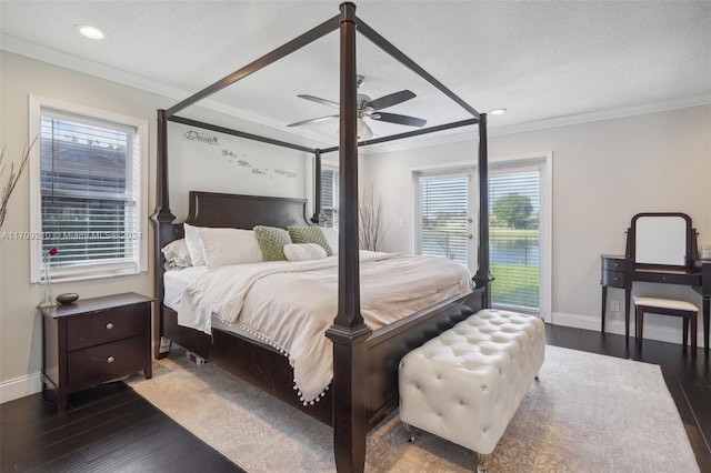 bedroom with multiple windows, ceiling fan, dark wood-type flooring, and ornamental molding