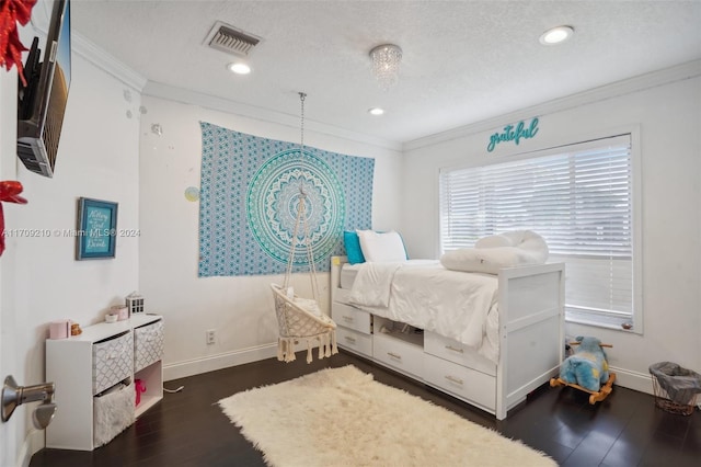 bedroom featuring a textured ceiling, dark hardwood / wood-style flooring, and crown molding