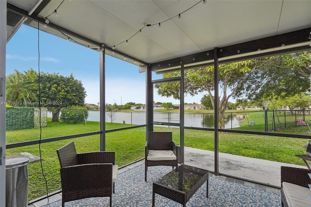 sunroom / solarium featuring a water view