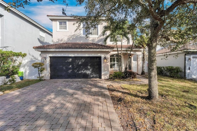 mediterranean / spanish house with a garage and a front lawn