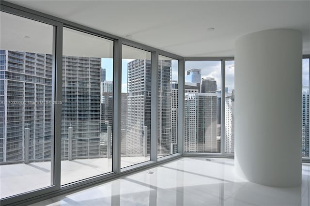 unfurnished room with floor to ceiling windows and a healthy amount of sunlight