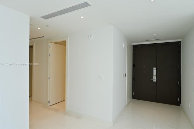 corridor featuring light tile patterned floors