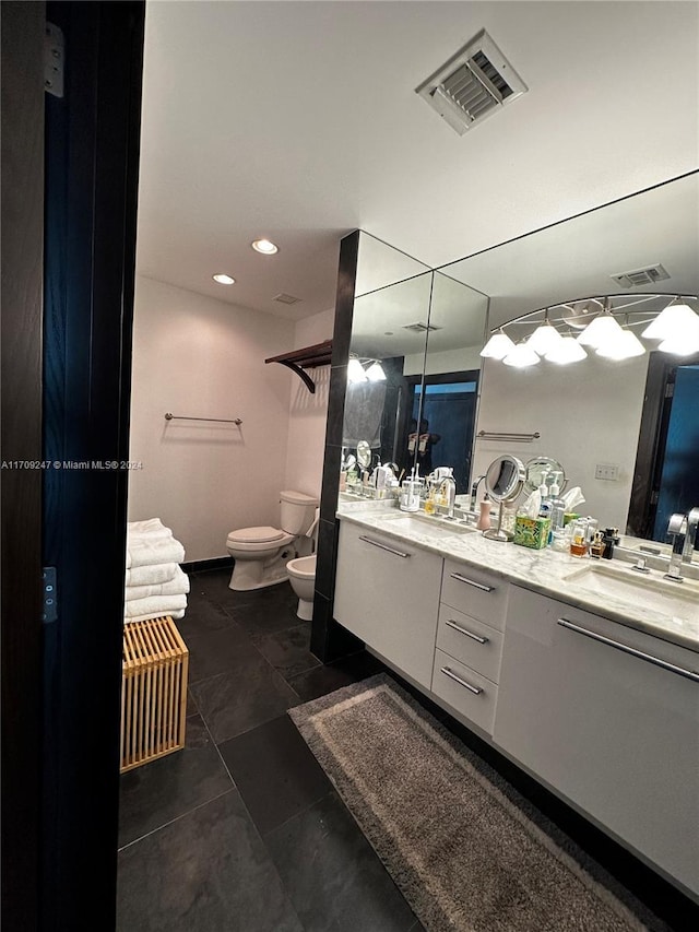 bathroom featuring vanity, tile patterned flooring, a bidet, and toilet