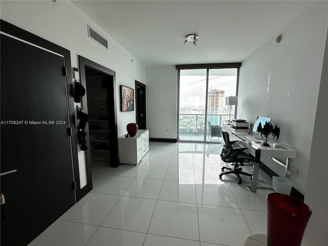 tiled office space featuring floor to ceiling windows