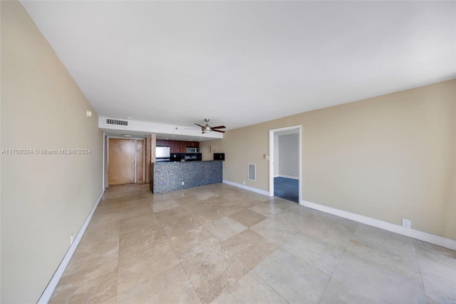 unfurnished living room featuring ceiling fan