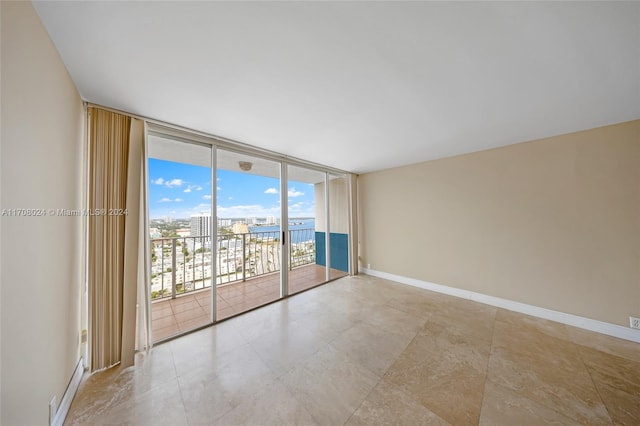 unfurnished room featuring expansive windows