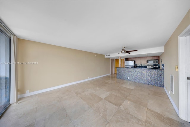 unfurnished living room featuring ceiling fan