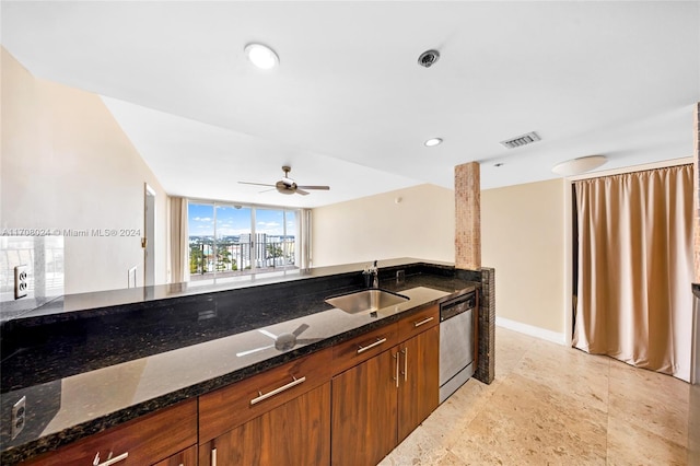 kitchen with stainless steel dishwasher, ceiling fan, dark stone countertops, and sink