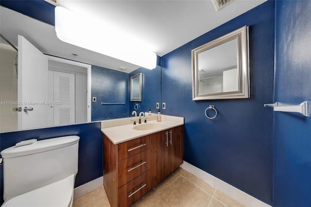 bathroom with tile patterned floors, vanity, and toilet