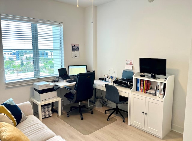 office space featuring plenty of natural light and light wood finished floors