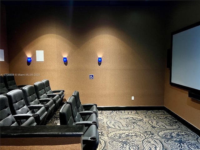 carpeted cinema room featuring baseboards