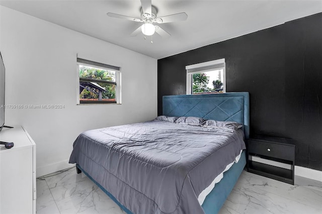 bedroom with multiple windows and ceiling fan