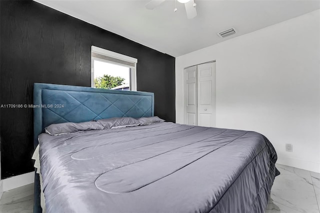 bedroom with ceiling fan and a closet