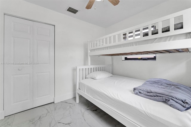 bedroom with ceiling fan and a closet