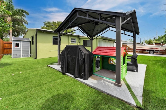 back of house featuring a gazebo, a yard, and a shed